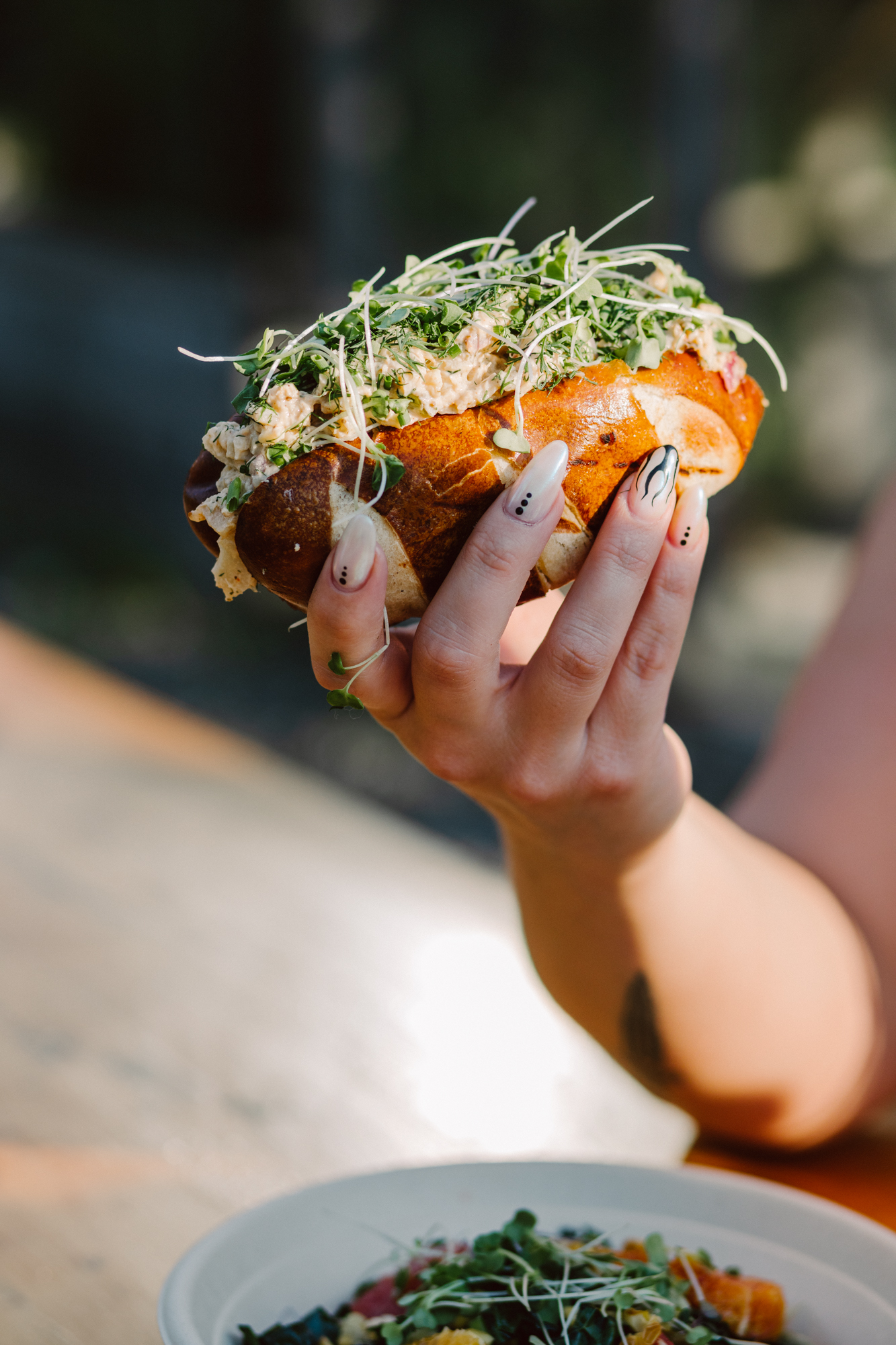 Hands passing a bowl at a candlelit table